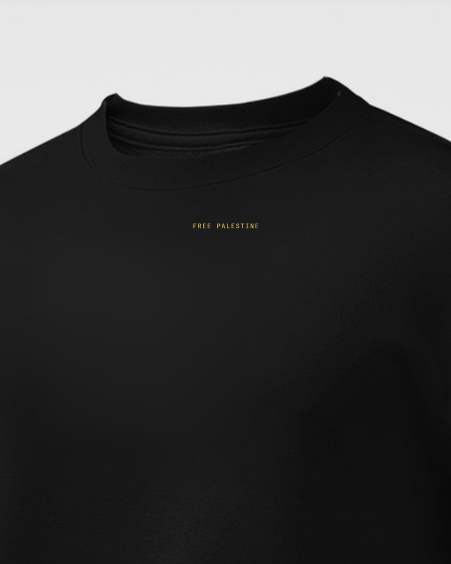 Black crewneck with FREE PALESTINE printed small in gold across the chest